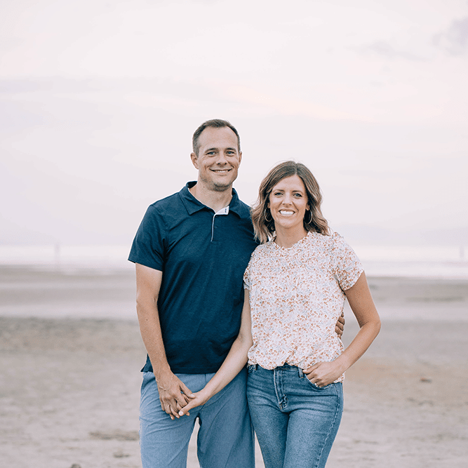Dr. Justin Nylander standing with a woman on a beach